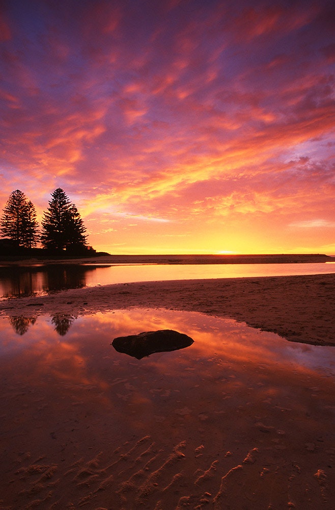 Skies Of Flame - One of the best sunrises I have ever seen, with its colours reflected in the still waters of Terrigal Lagoon. Taken in July 2003. (Image...